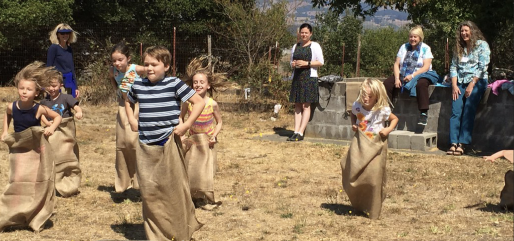 Kids racing during a sack race